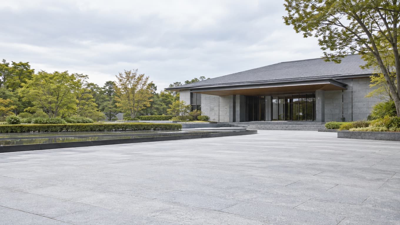 小規模火葬場の整備と「住宅から250m」規制の見直し　東京都の検討会が論点案（イメージ画像：木立に囲まれた低層の静かな建物と石畳の小道）